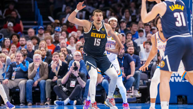 Denver Nuggets center Nikola Jokić jostles for position in the post against Oklahoma City Thunder guard Shai Gilgeous-Alexander.